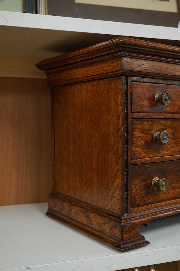 A Victorian oak miniature chest with sliding top, 31.5cm wide, 32cm high. Condition - good